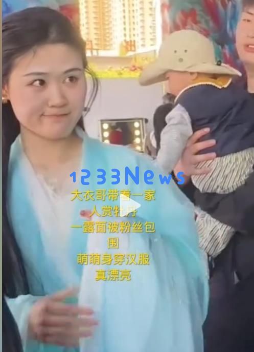 朱之文带着儿媳走进菏泽牡丹园，儿媳宛如花仙子，自己仍在使用苹果六手机